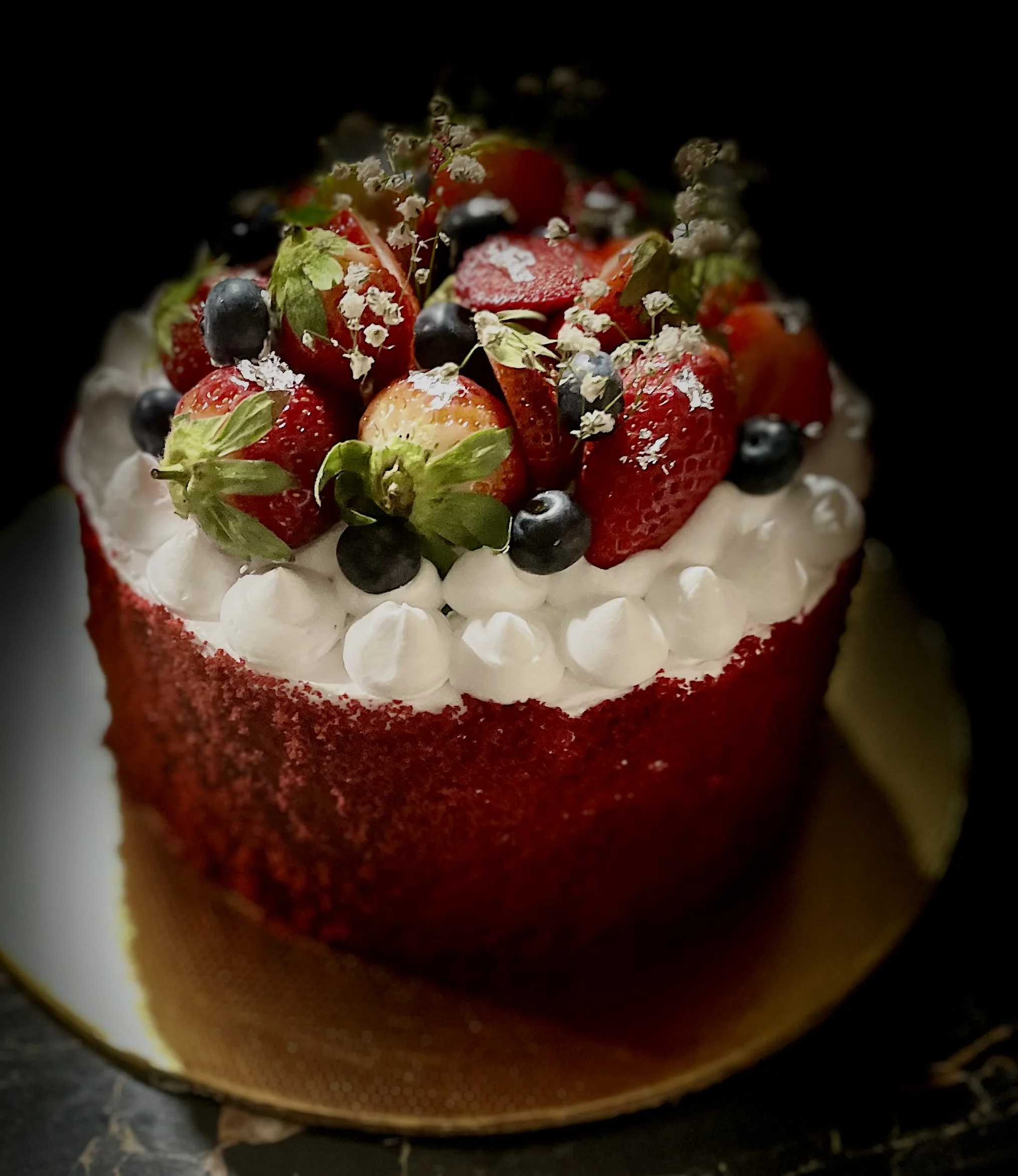 Velours Rouge — red velvet cake with billowing crème Chantilly, strawberries and blueberries